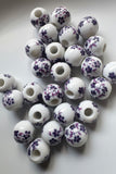 purple and white flower ceramic beads uk